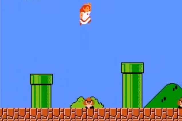 16 bit video game screen showing Princess Peach wearing a white dress with red trim jumping between two green pipes against a clear blue sky with a goomba running around on the ground below.